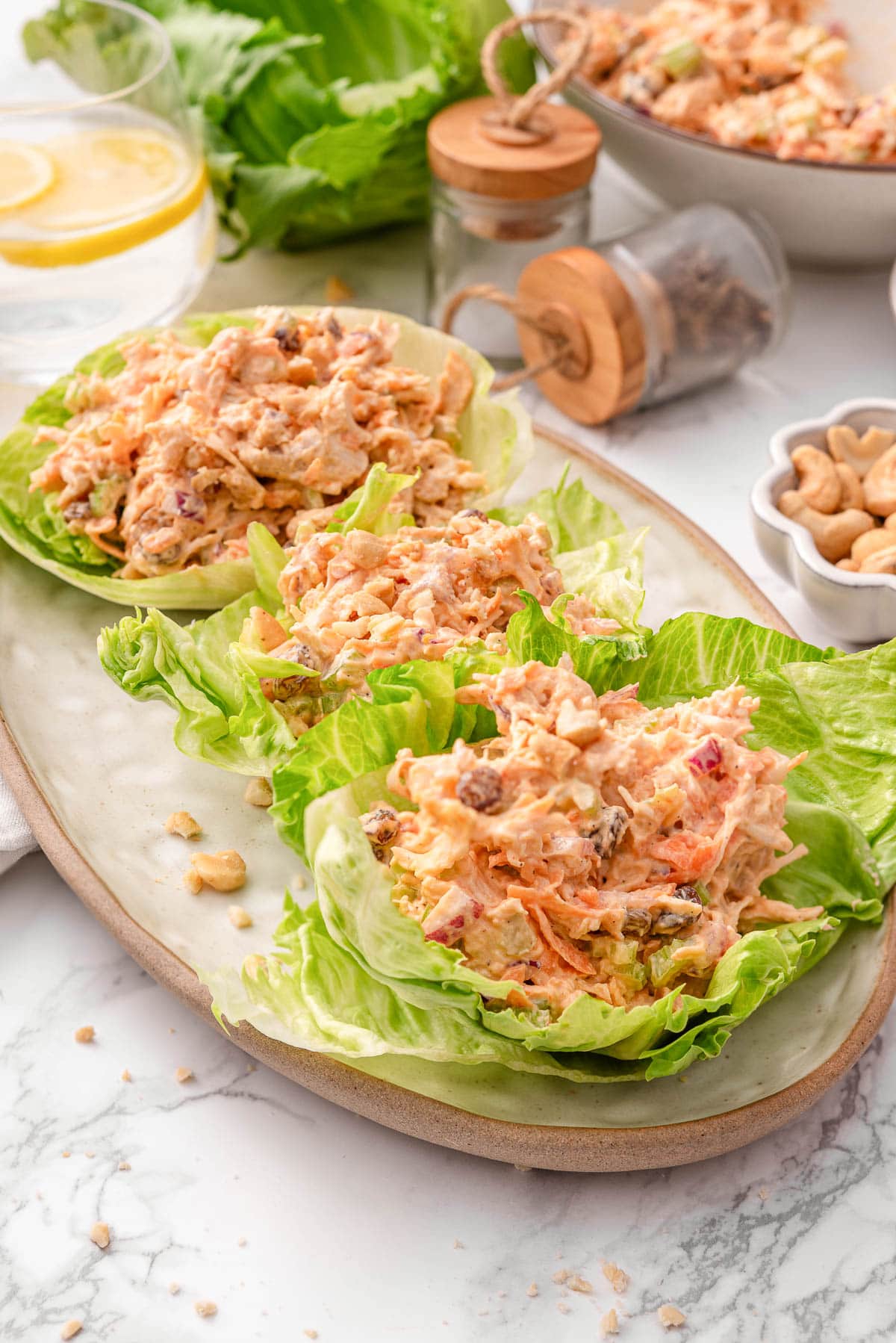 Buffalo chicken salad wraps on a platter.