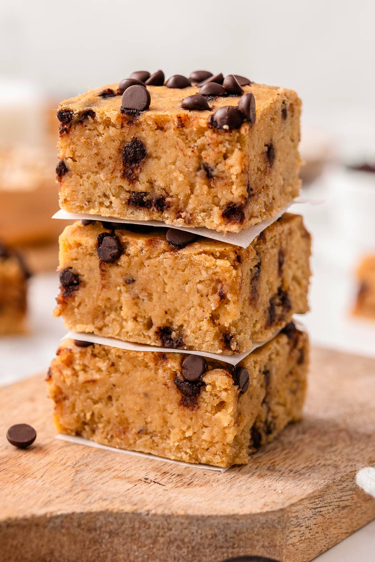 Three chickpea blondies stacked on a board.