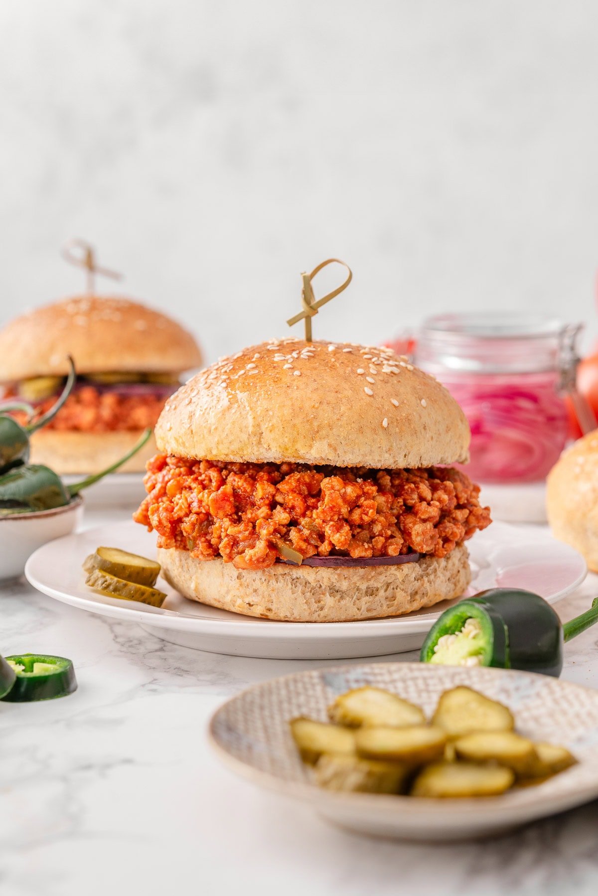 Two turkey sloppy joes sandwiches on plates.