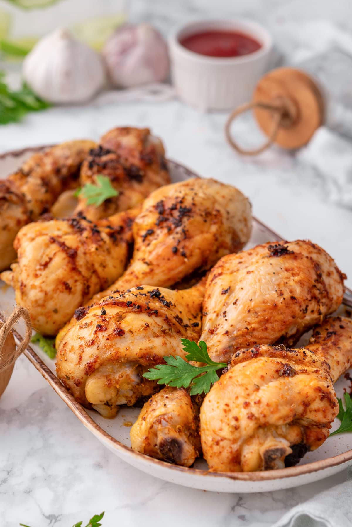 Baked chicken drumsticks on a platter.