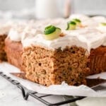Slice of healthy zucchini cake on a wire rack.