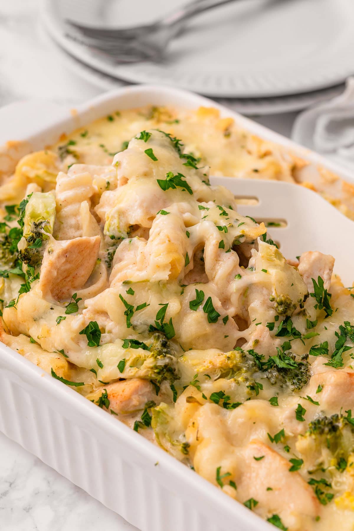 Chicken alfredo bake on a serving spatula.