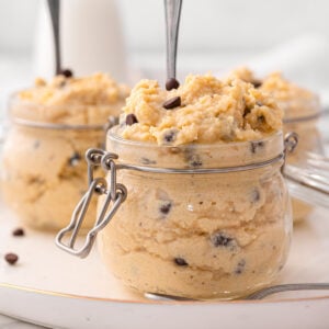 Greek yogurt cookie dough in glass jars with spoons.
