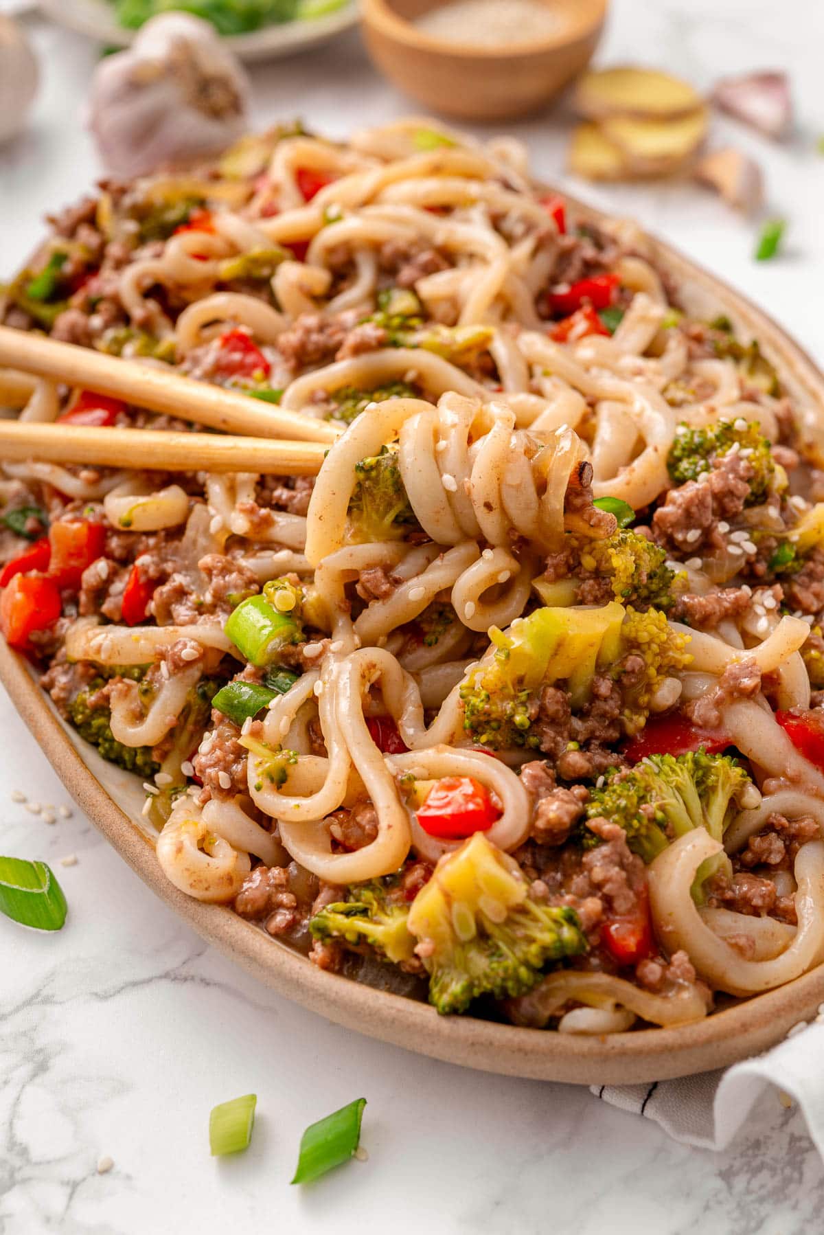 Closeup of stir fry with ground beef and udon noodles.
