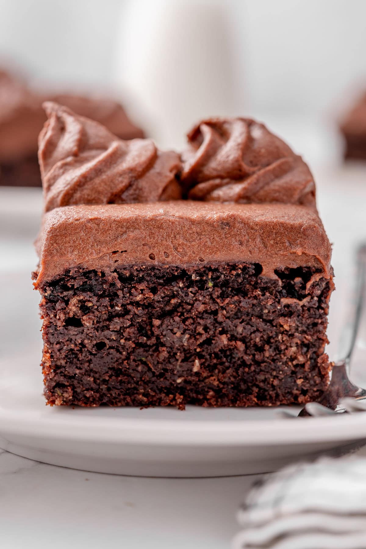 A slice of healthy chocolate zucchini cake on a plate.