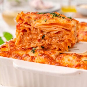 High protein baked ziti on a spatula in a baking dish.