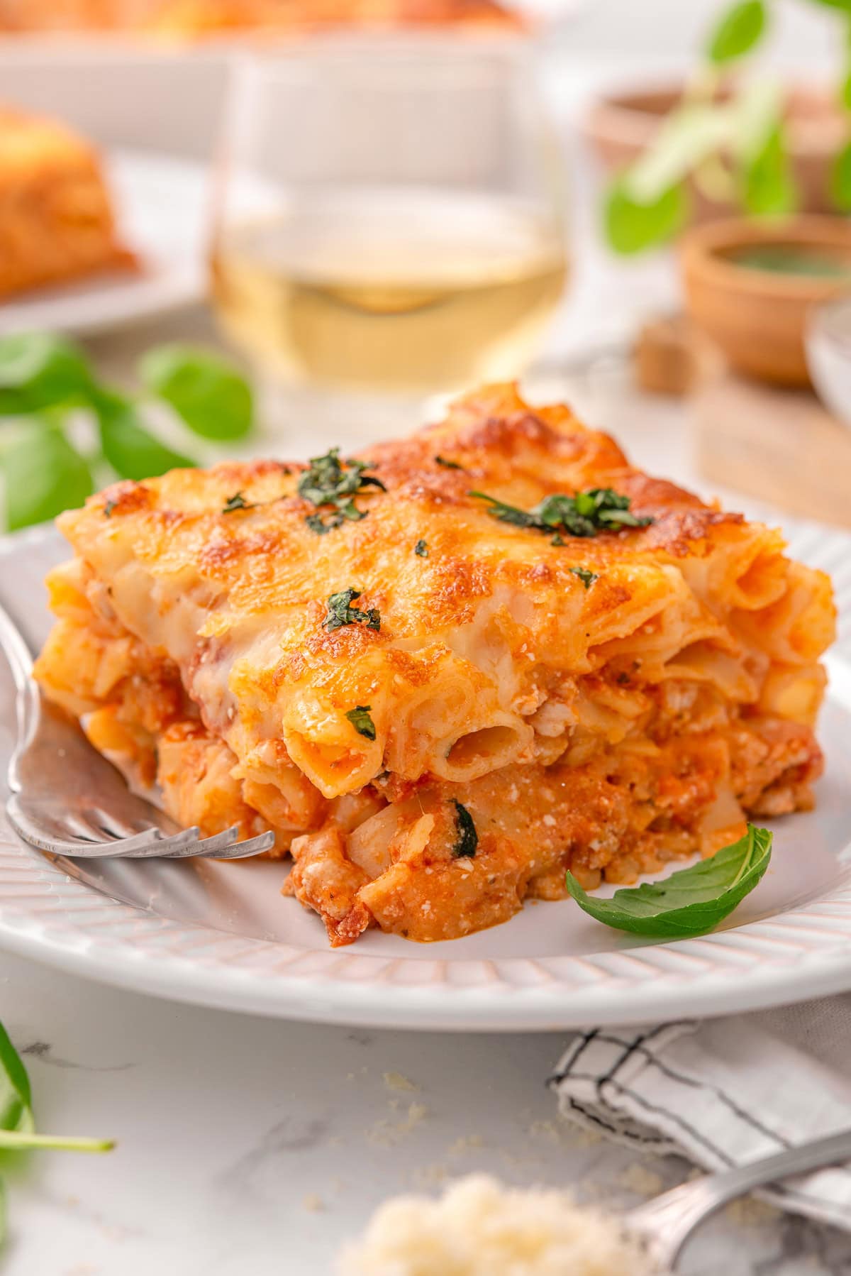 Side view of high protein baked ziti served on a plate with a fork.