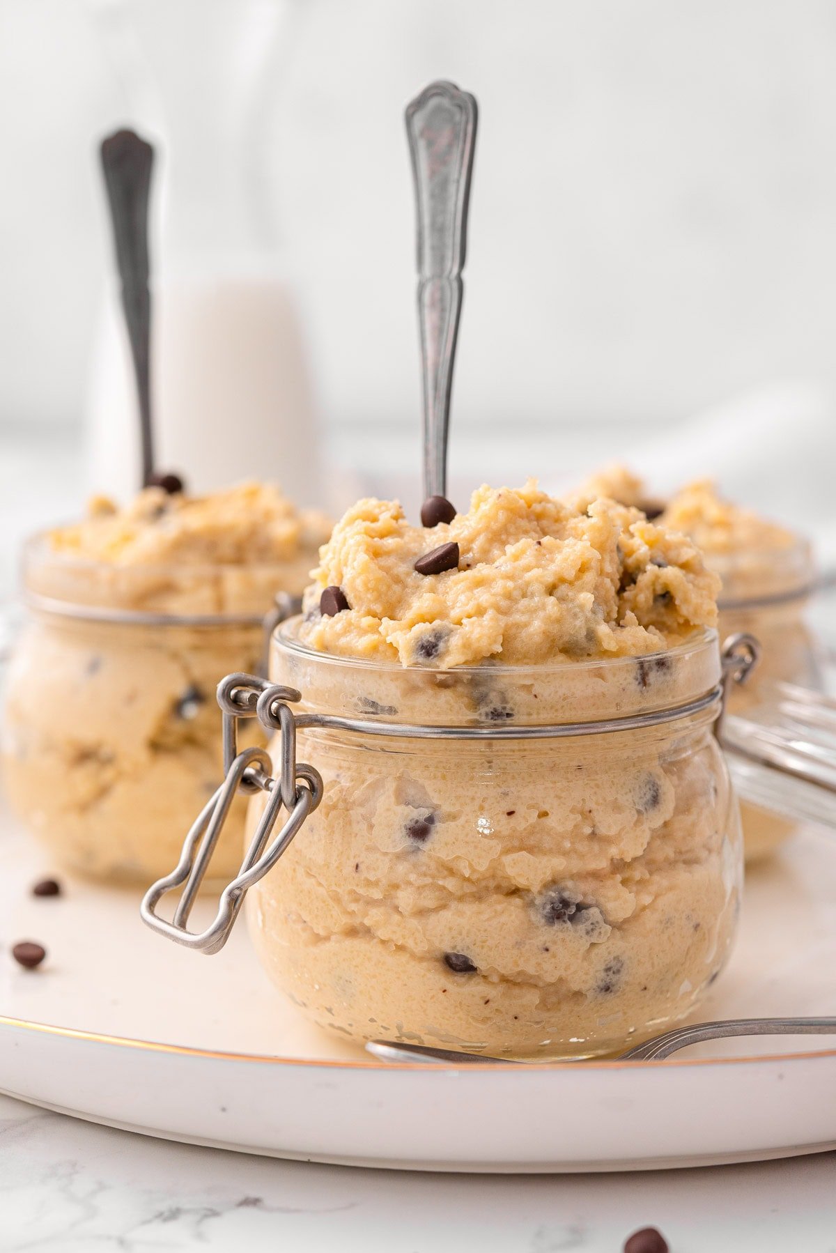 Greek yogurt cookie dough in jars with spoons.