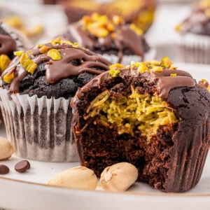 Dubai chocolate muffins showing filling inside on a plate.