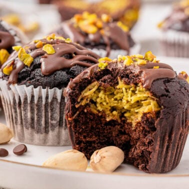 Dubai chocolate muffins showing filling inside on a plate.