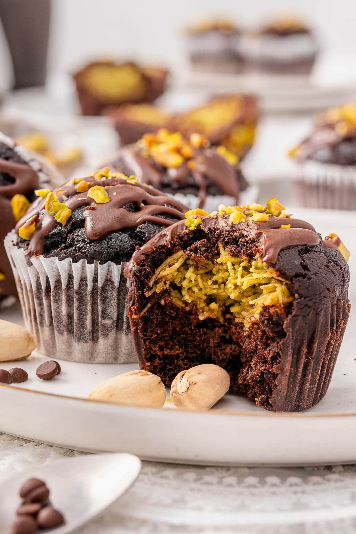 Dubai chocolate muffins showing the filling inside on a plate.