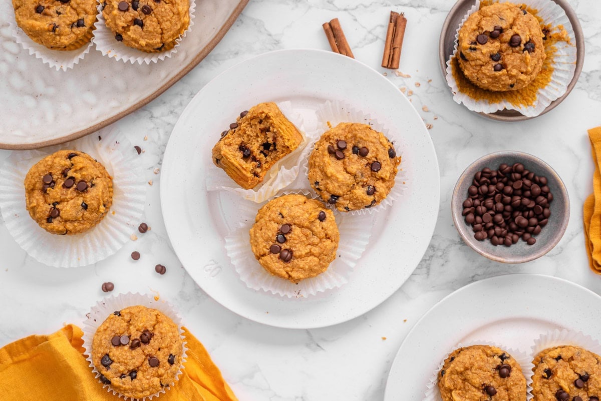 Sweet potato muffins on plates, chocolate chips in a bowl.