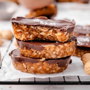 A stack of three no bake peanut butter oat cups.