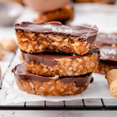 A stack of three no bake peanut butter oat cups.