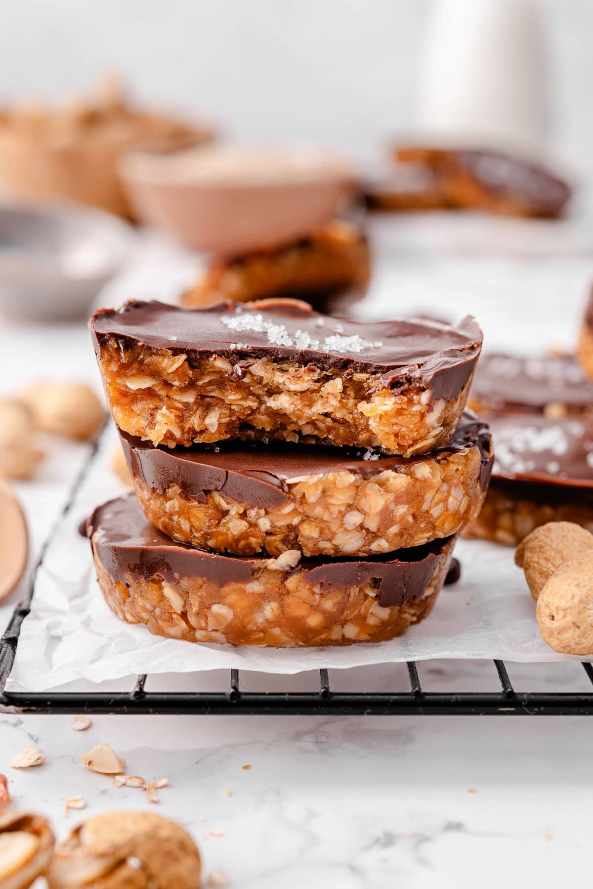 Three no bake peanut butter oat cups stacked on top of each other.