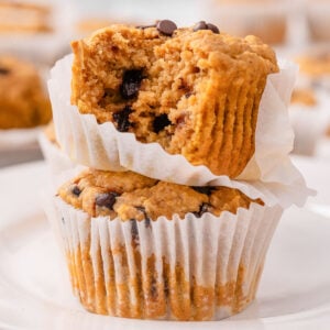 Two sweet potato muffins one showing texture inside.