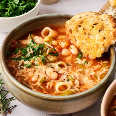 Minestrone soup in a bowl with bread.