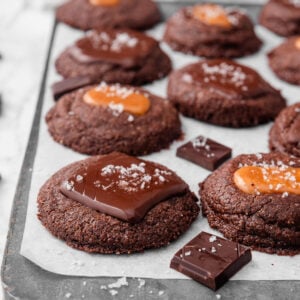 3 ingredient nutella cookies with caramel and chocolate on a baking sheet.