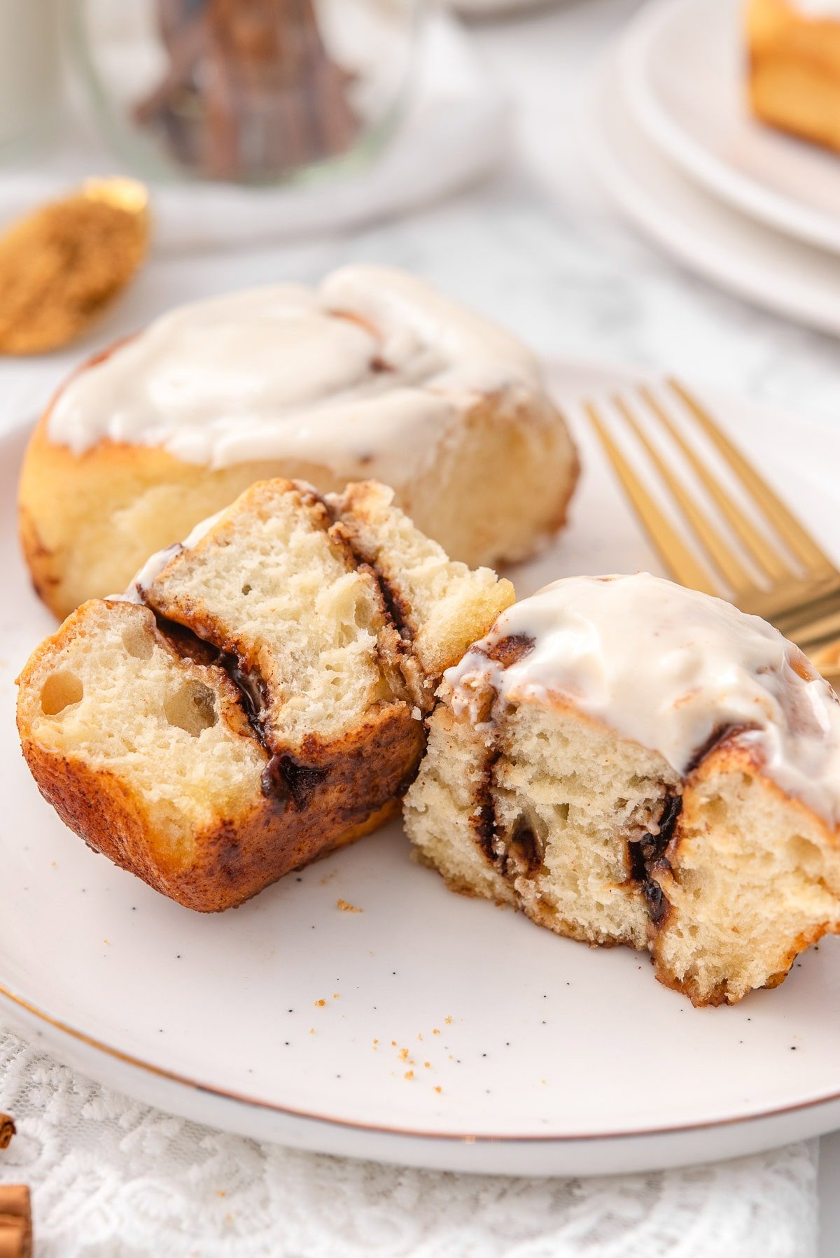 Cottage cheese cinnamon rolls showing texture inside on a plate.