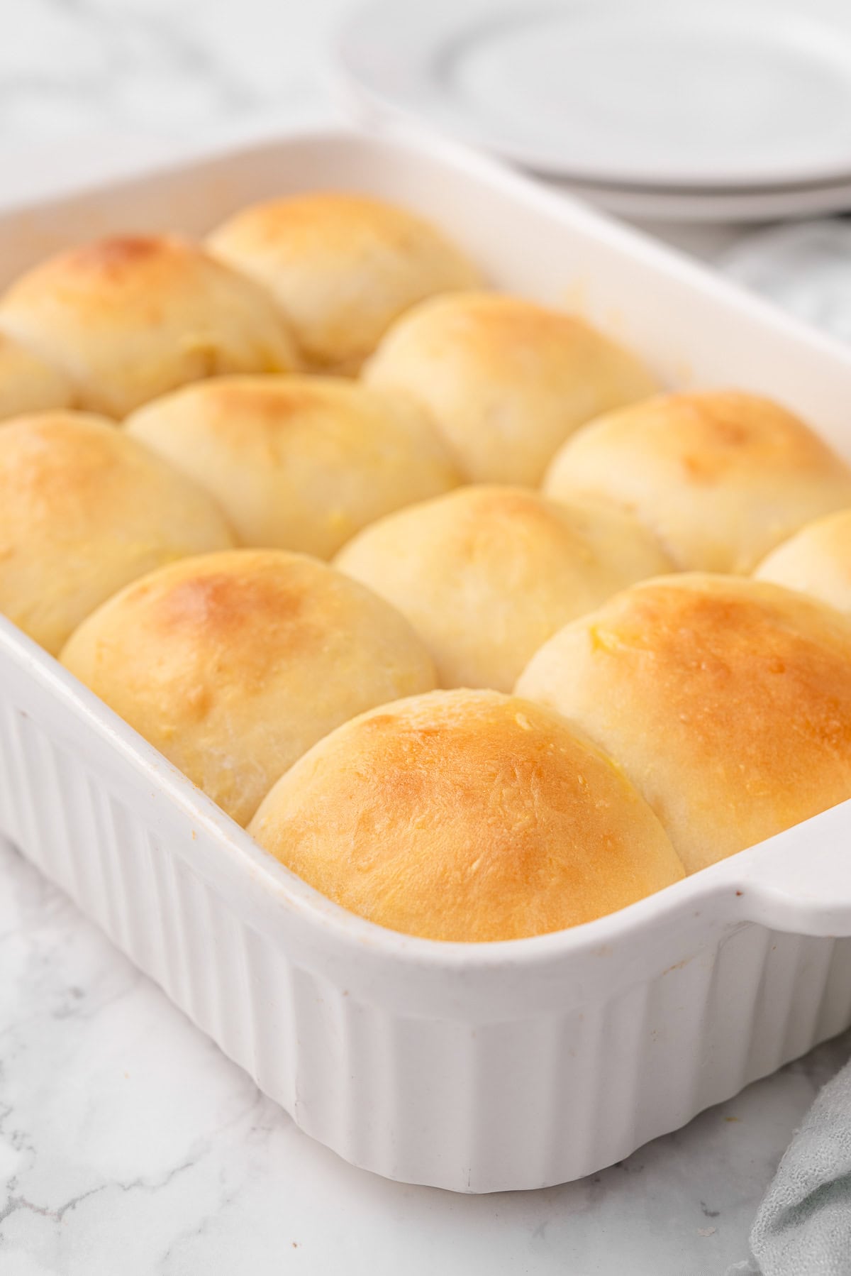 Greek yogurt dinner rolls in a baking dish.