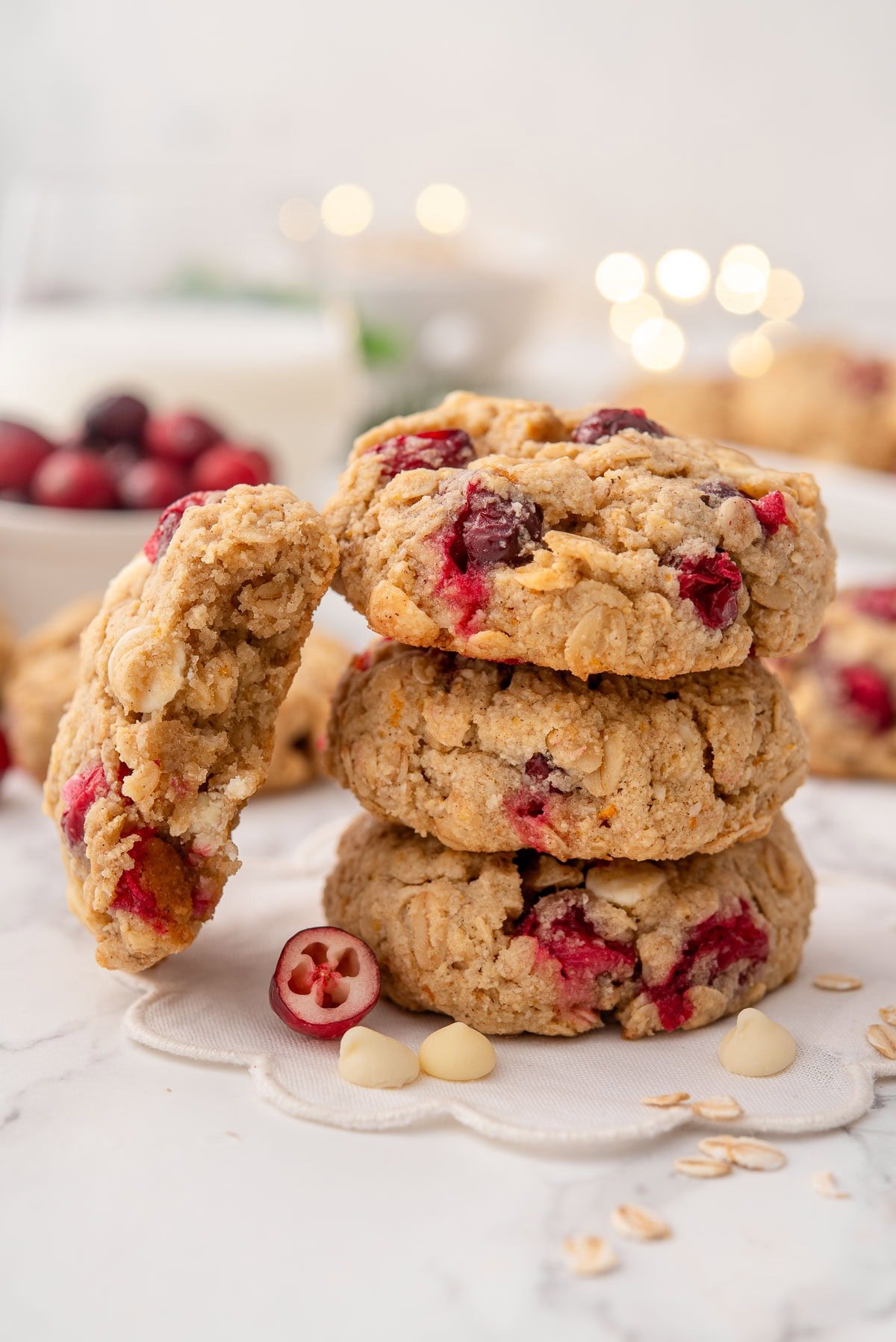 A stack of healthy oatmeal cranberry cookies with one showing texture inside.