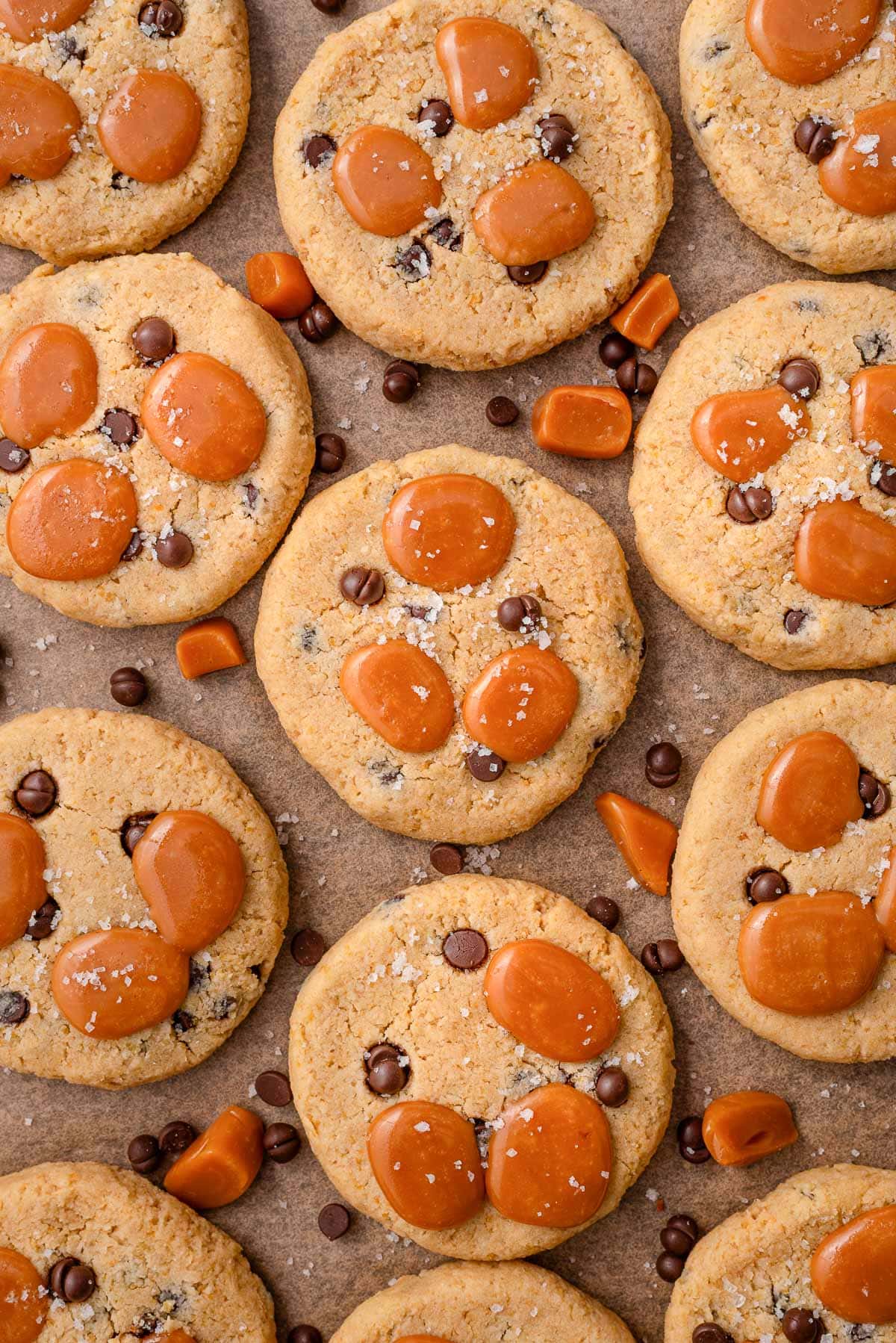 Salted caramel chocolate chip chickpea cookies with sea salt and chocolate on baking sheet.