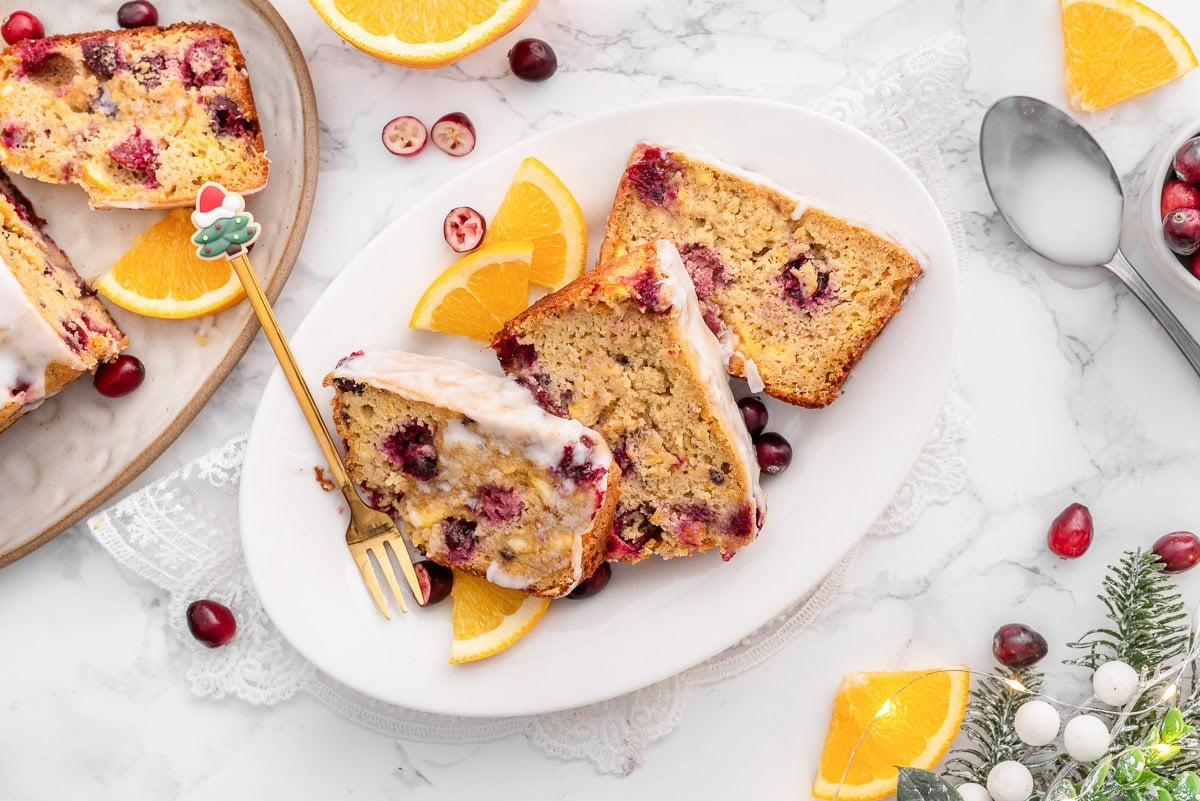 Slices of cranberry orange bread on a plate.