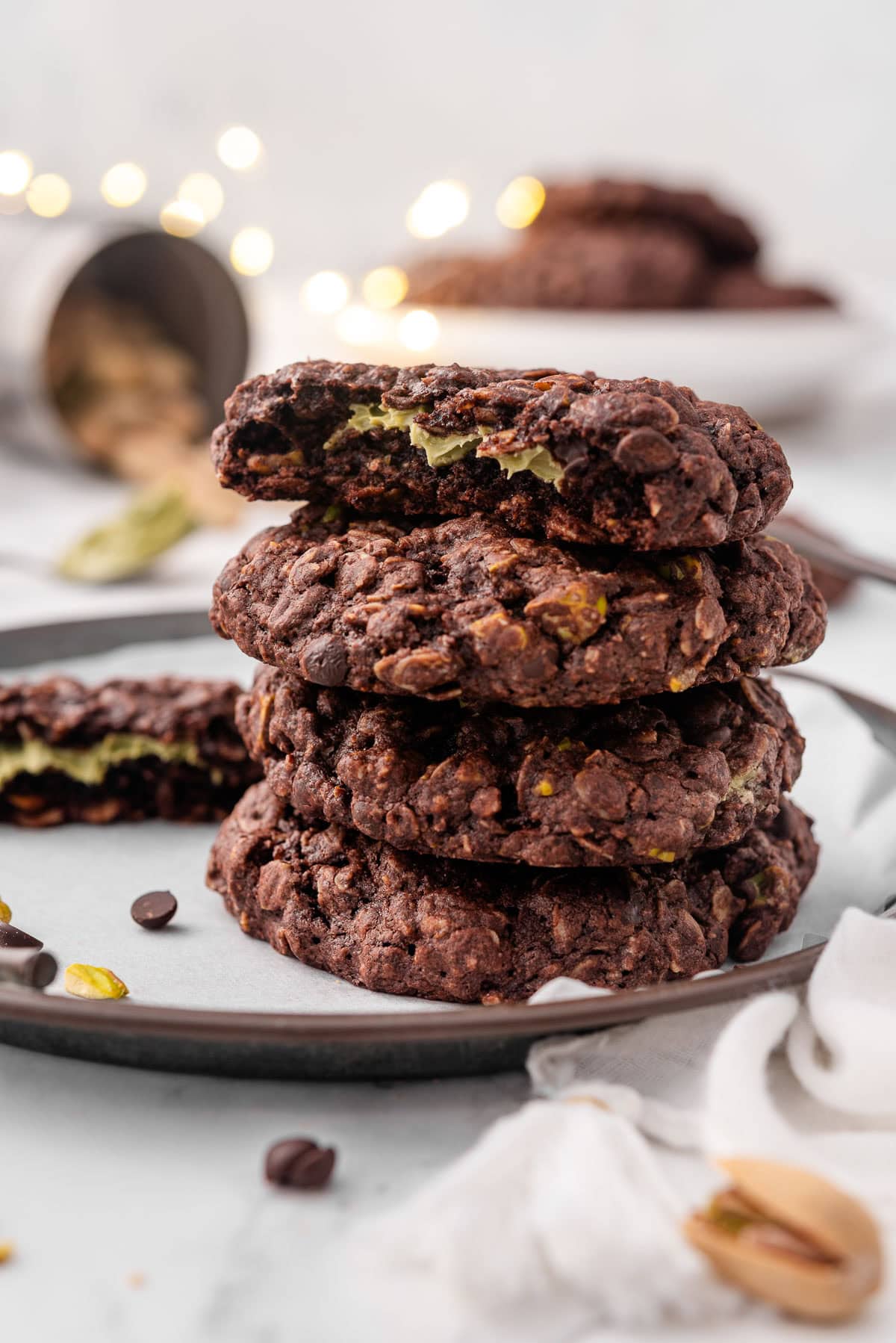 A stack of Dubai chocolate oatmeal cookies with top one showing filling inside.