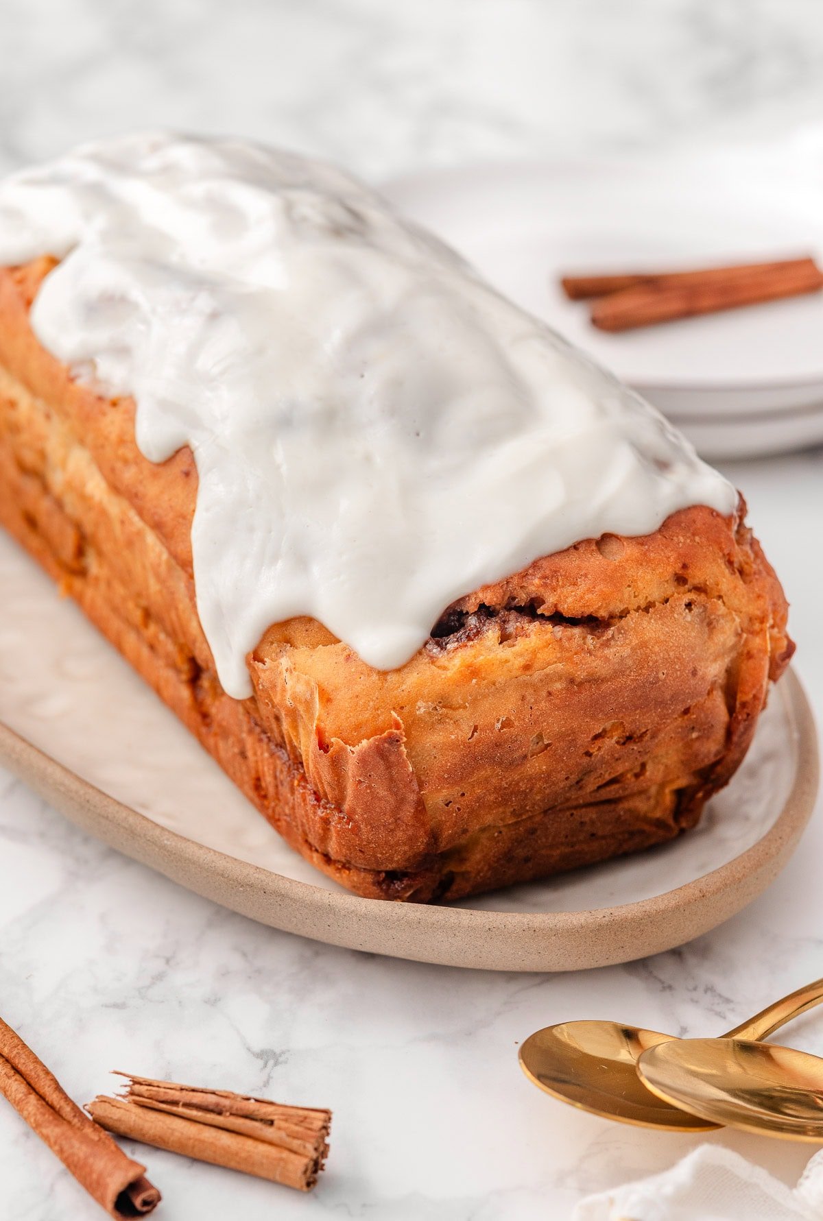 Greek yogurt cinnamon roll bread with Greek yogurt frosting on top.