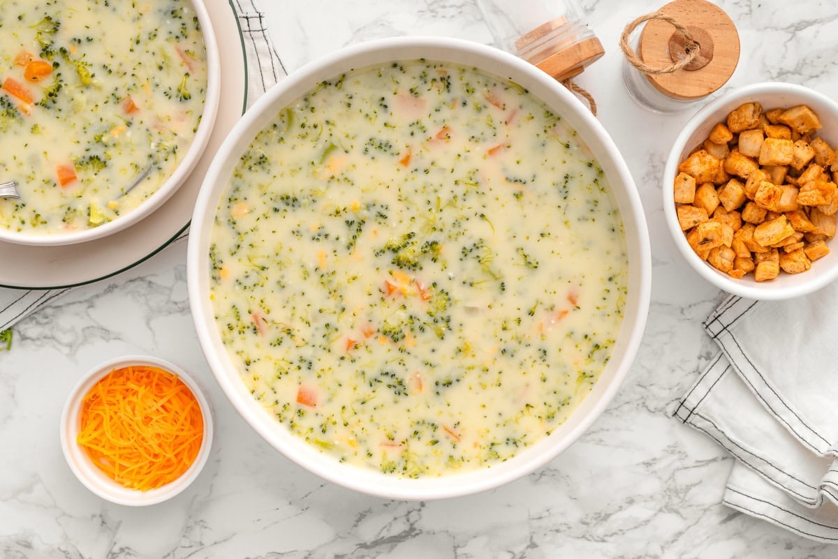 High protein broccoli cheddar soup i nab owl. Cheese and chicken in serving bowls.