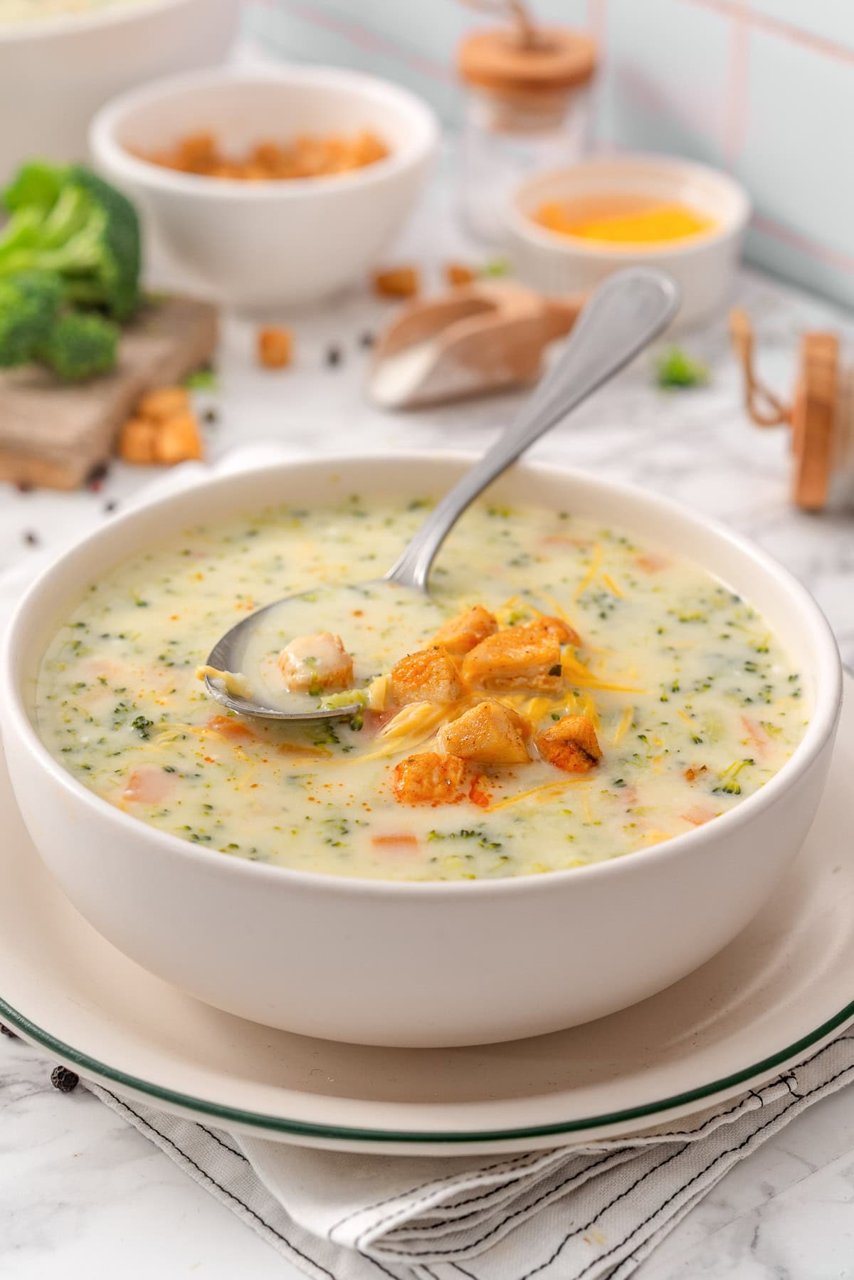 High protein broccoli cheddar soup with chicken in a bowl.
