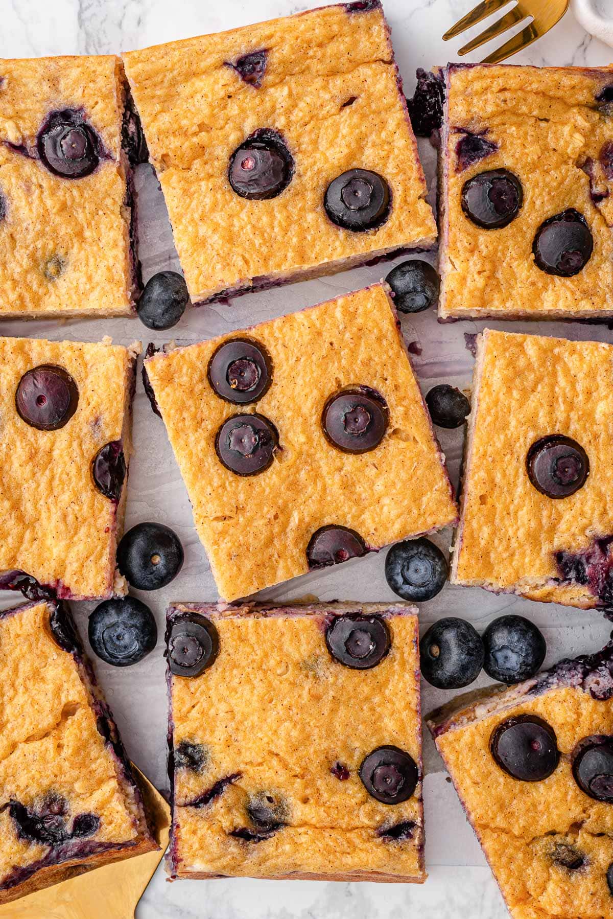 Blueberry cottage cheese breakfast bake sliced on a parchment paper.