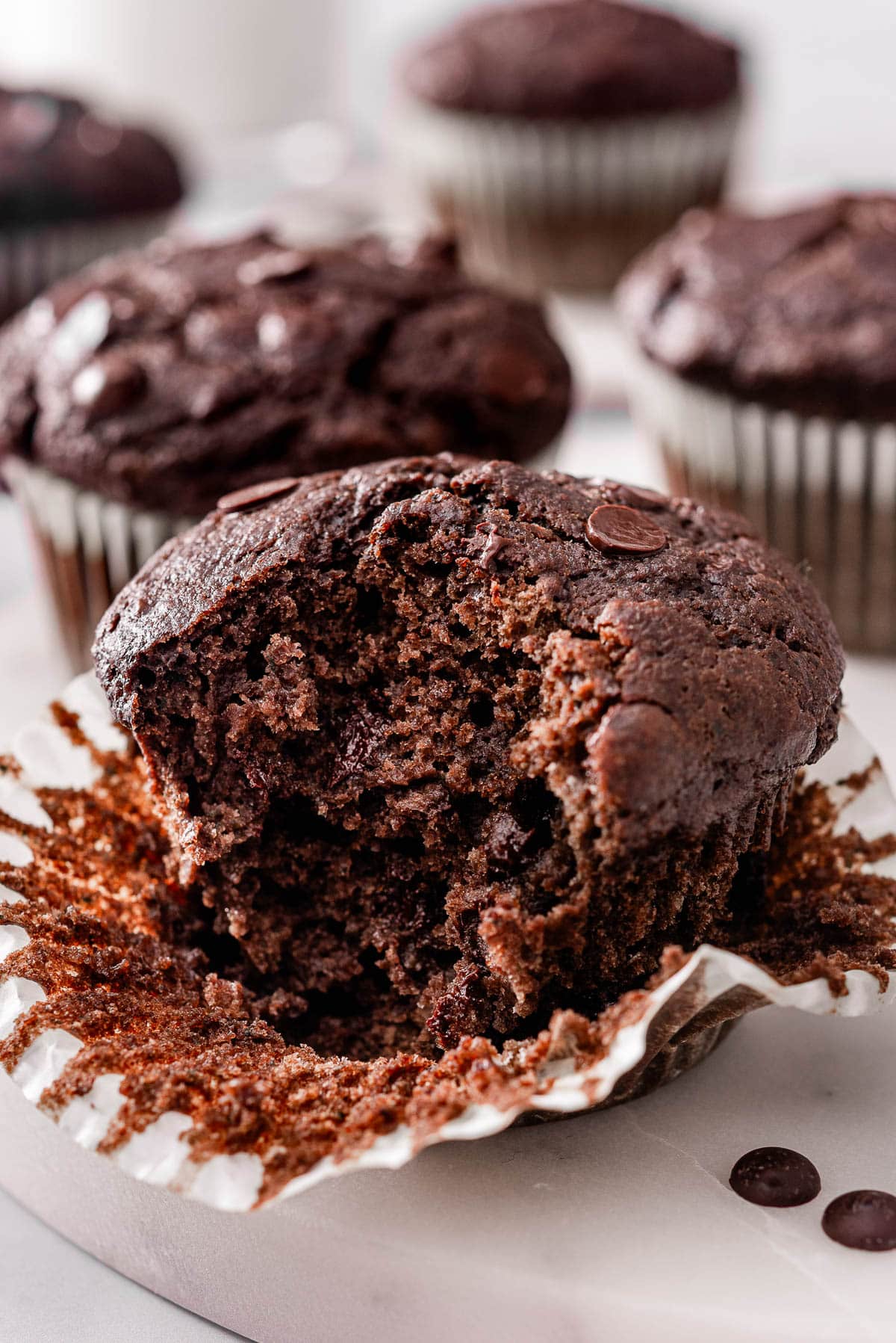Chocolate veggie muffin unwrapped and showing texture inside.