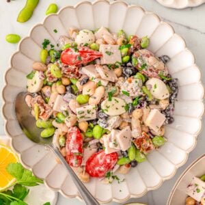 Dense bean salad in a serving dish with spoon.