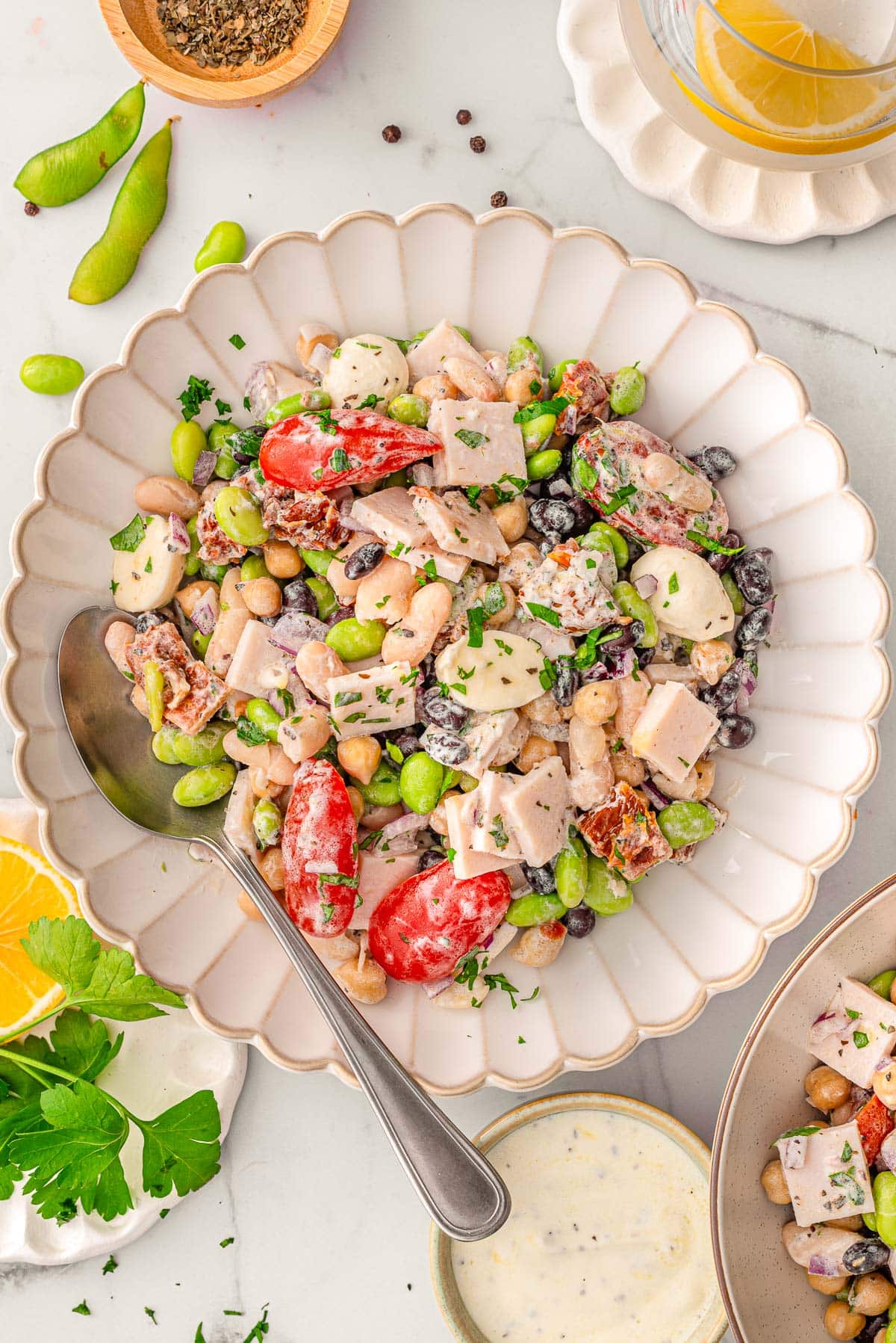 Dense bean salad in a serving dish with spoon.