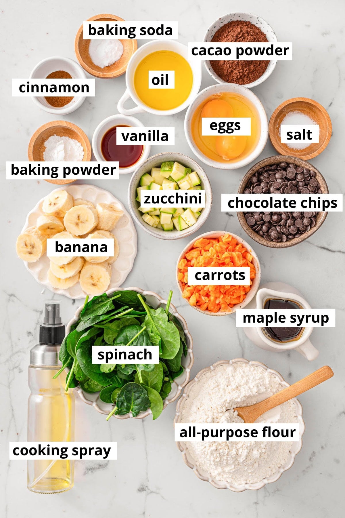 Spinach, carrots, banana, zucchini, cacao powder, chocolate chips, flour, cooking spray, oil, maple syrup, vanilla, salt, eggs, baking powder, baking soda, cinnamon.