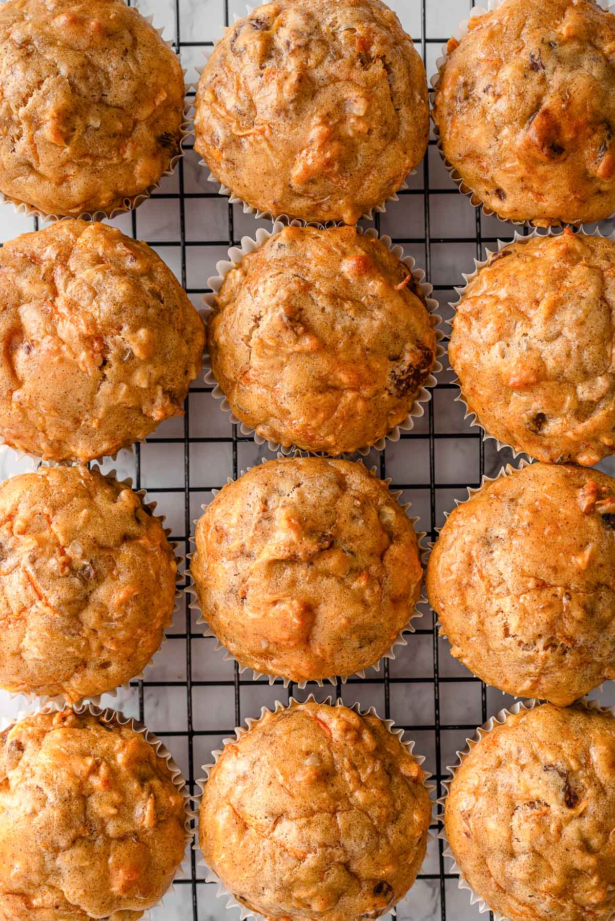 Cottage cheese carrot cake muffins on a wire rack.