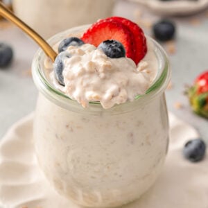 Greek yogurt overnight oats scooped with a spoon in a jar.