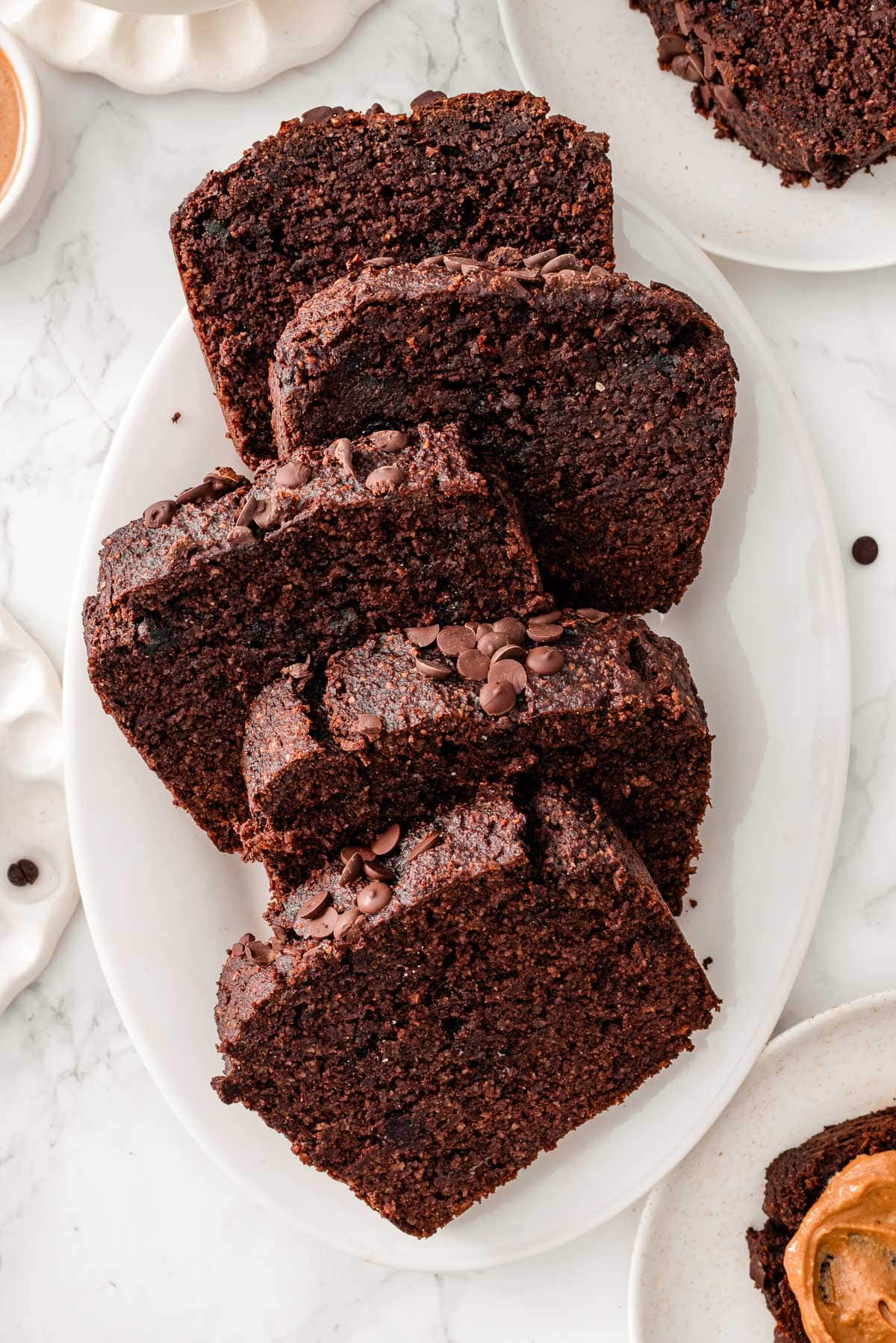 Sliced healthy chocolate banana bread on a platter.