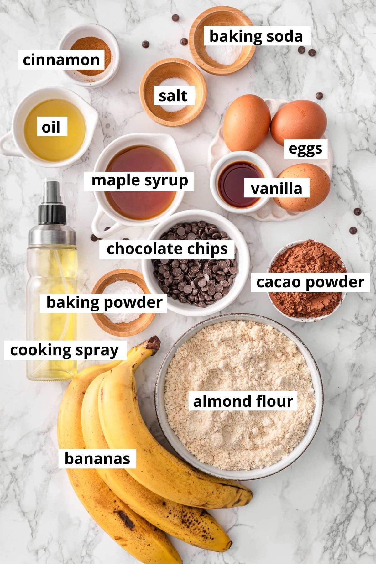 Almond flour, bananas, eggs, maple syrup, vanilla extract, cacao powder, chocolate chips, cooking spray, avocado oil, cinnamon, baking soda, baking powder, salt.