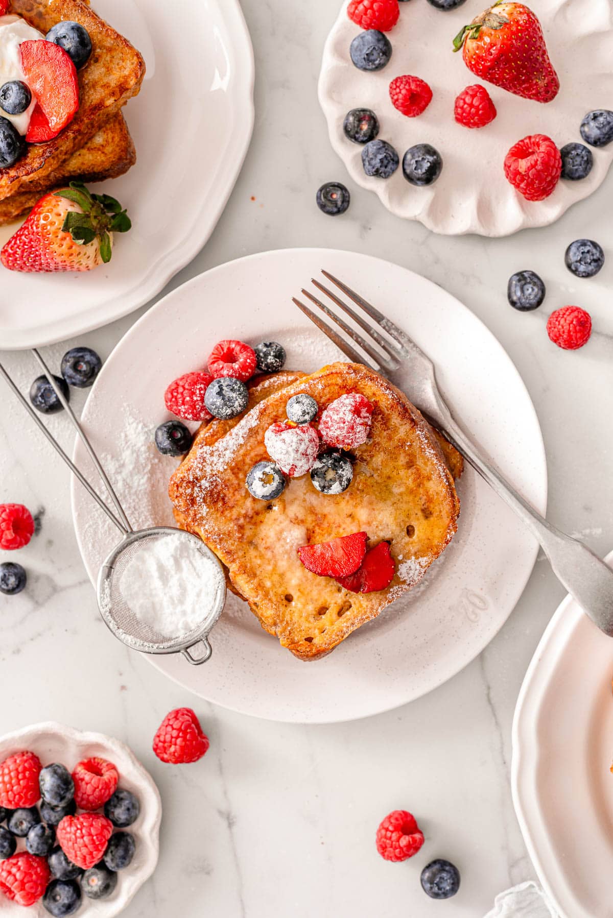 Looking down on plates with high protein french toast and berries.