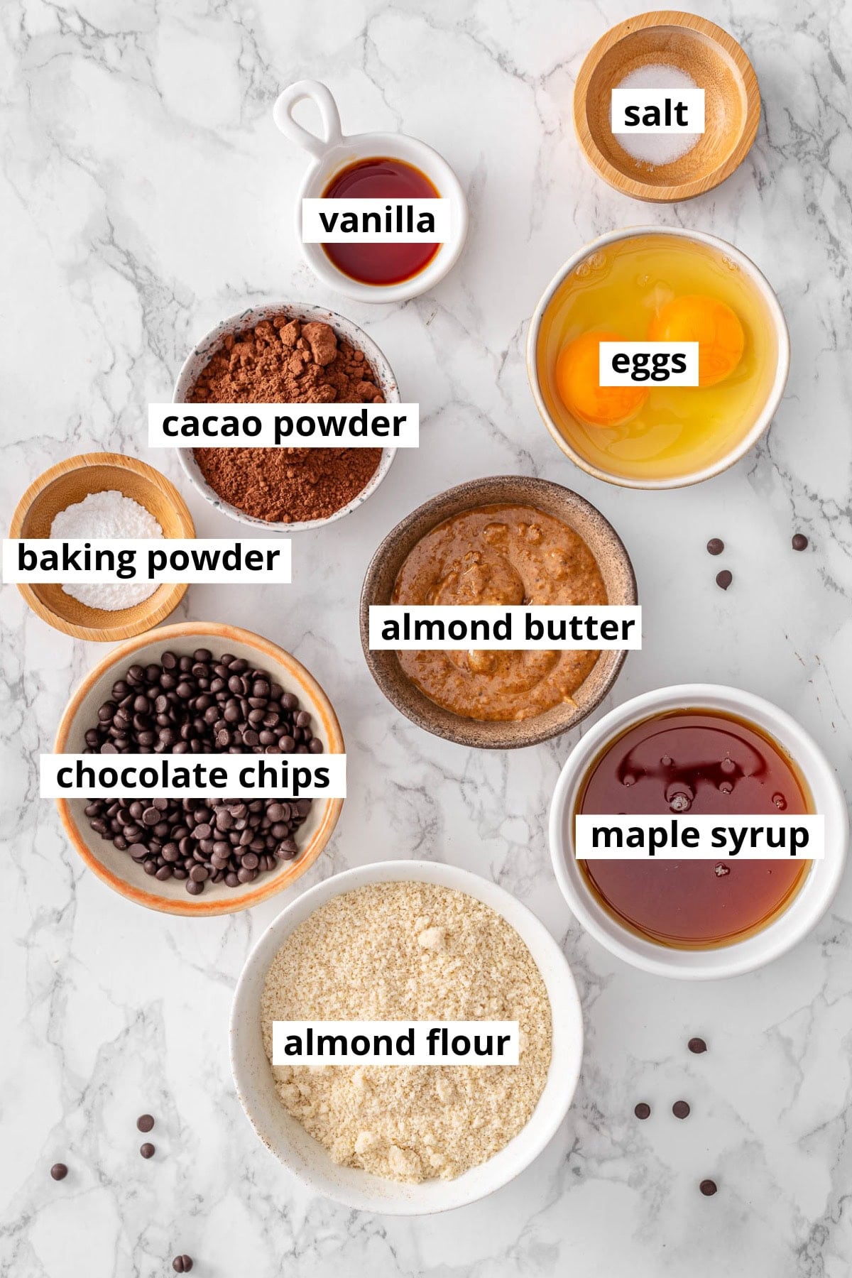 Almond flour, cacao powder, chocolate chips, maple syrup, eggs, vanilla extract, baking powder, almond butter, salt.