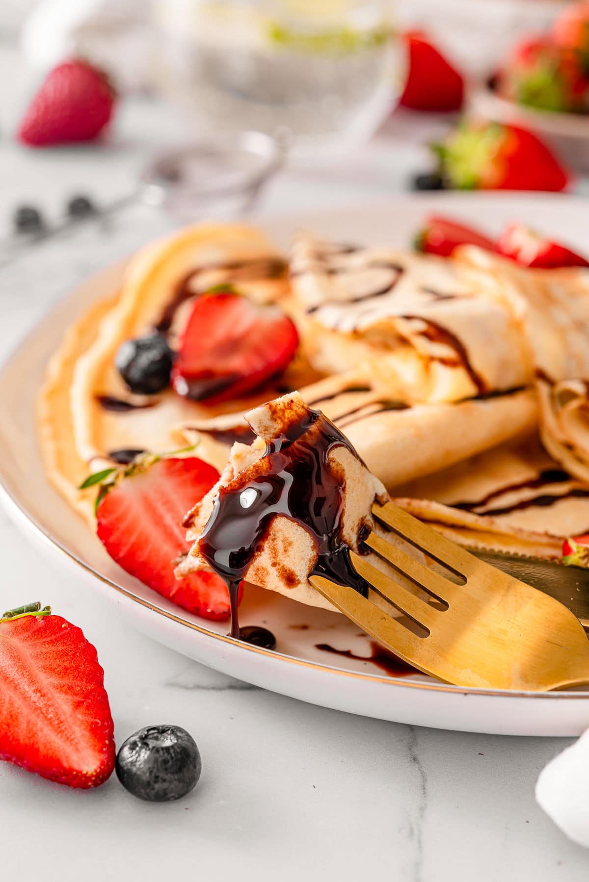 Chocolate sauce dripping from crepe with cottage cheese.