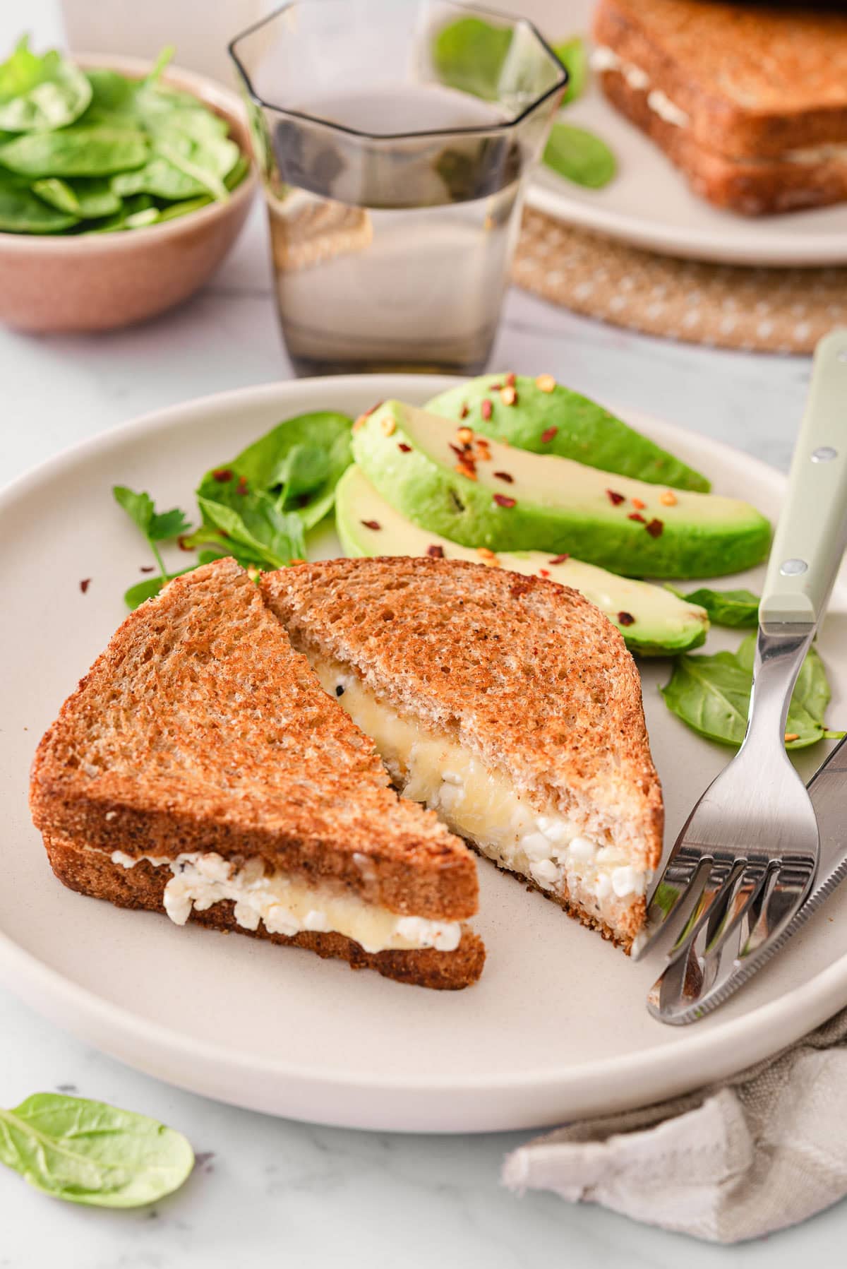 Cottage cheese grilled cheese served with veggies and avocado.