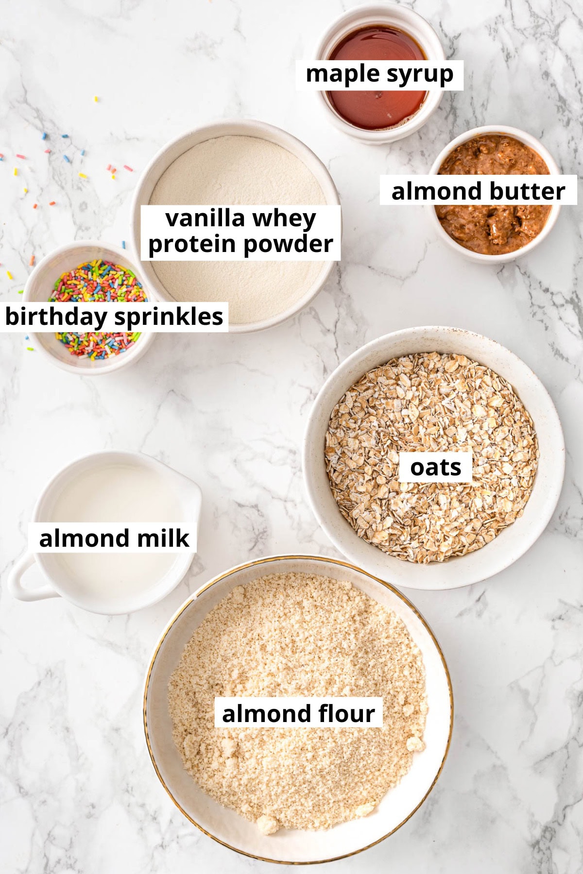 Oats, whey protein powder, almond butter, almond milk, maple syrup, birthday sprinkles, almond flour.